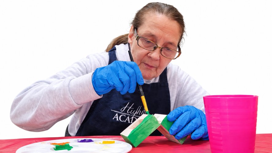 Someone painting a box
